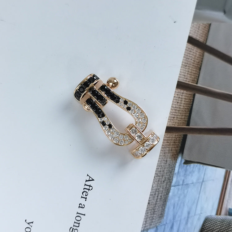 [BLAUE TRÄNEN]FORCE GROSSES HUFEISENARMBAND MIT SCHWARZEN WEISSEN DIAMANTEN UND ROSÉGOLD
