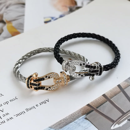 [BLAUE TRÄNEN]FORCE GROSSES HUFEISENARMBAND MIT SCHWARZEN WEISSEN DIAMANTEN UND ROSÉGOLD