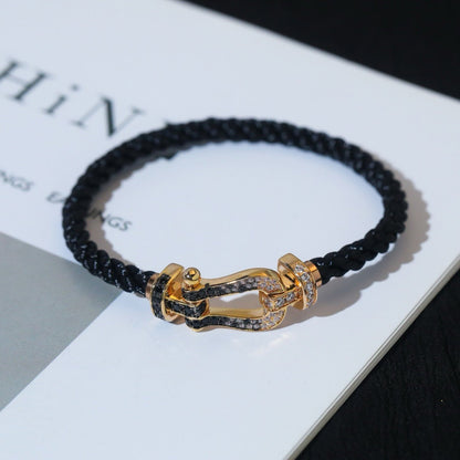 [BLAUE TRÄNEN]FORCE GROSSES HUFEISENARMBAND MIT SCHWARZEN WEISSEN DIAMANTEN UND ROSÉGOLD